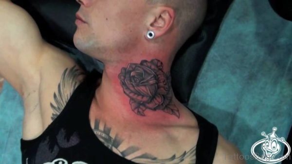 Adorable Black Rose Tattoo On Neck