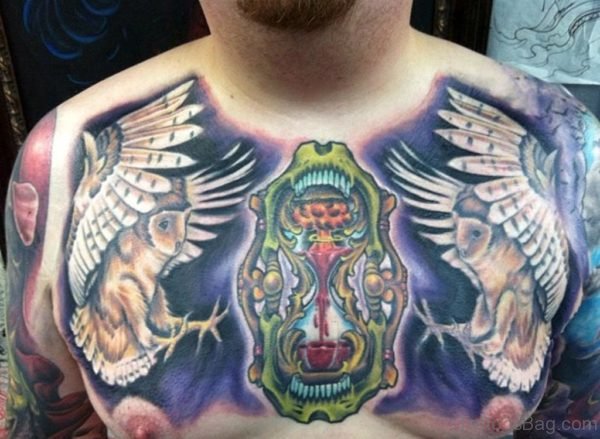 Amazing Watercolor Hourglass With Flying Owl Tattoo On Man Chest
