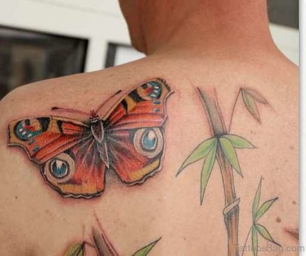 Eyes And Butterfly Tattoo On Back