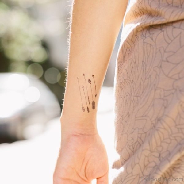 Five Small Arrows Tattoo On Wrist