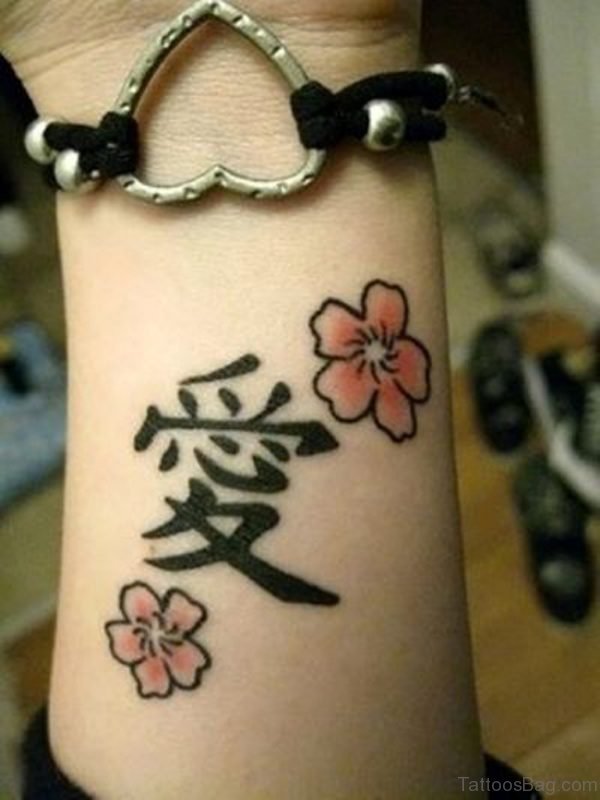 Flower And Chinese Word Tattoo On Wrist