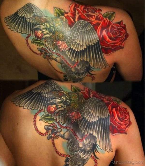 Flying Crow And Lovely Red Flowers Tattoo