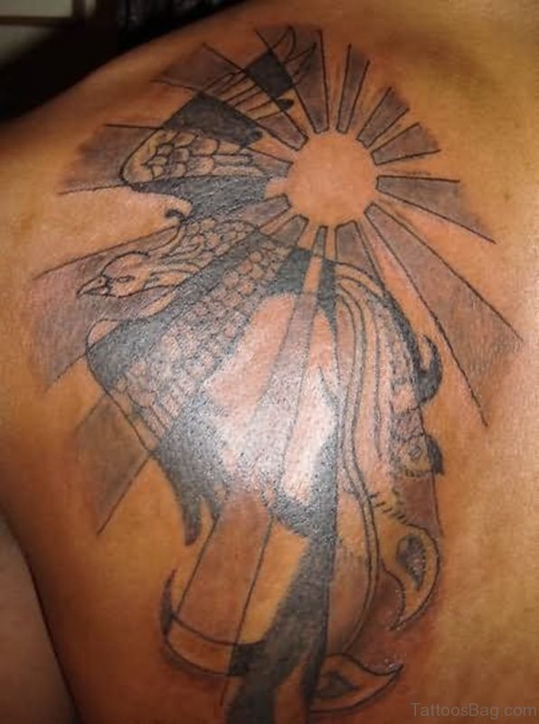 Flying Phoenix And Sun Rays Tattoo On Back Shoulder