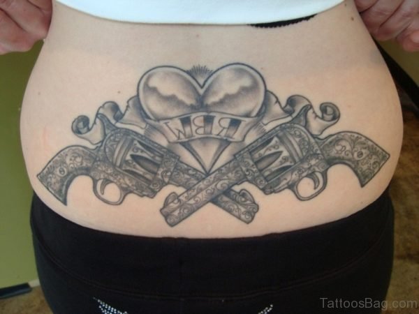 Grey Ink Heart And Guns Tattoo On Lower Back 