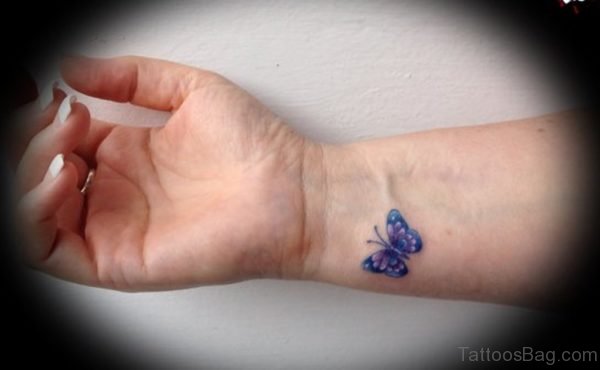 Tiny Blue Butterfly Tattoo On Wrist