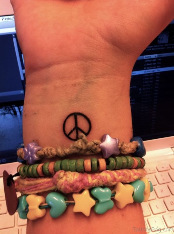 Tiny Peace Tattoo On Wrist