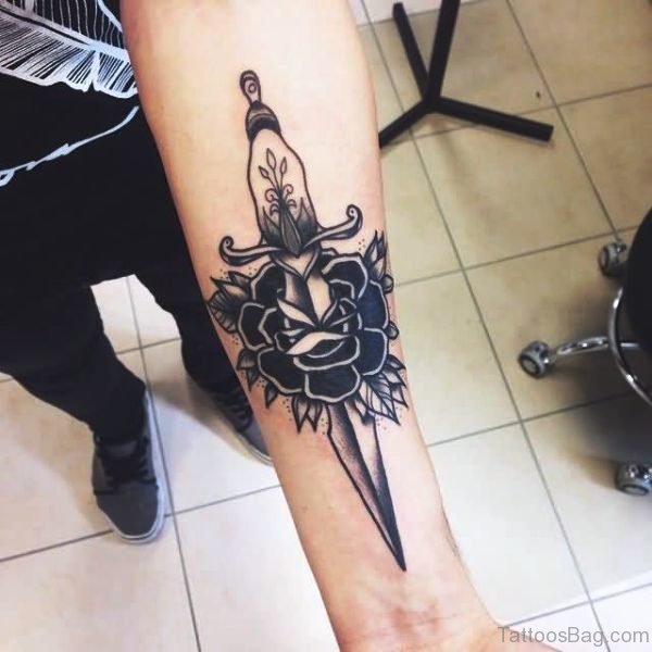 Attractive Black Dagger Tattoo On Arm