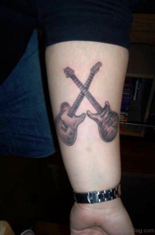 Attractive Cross Guitar Tattoo On Forearm