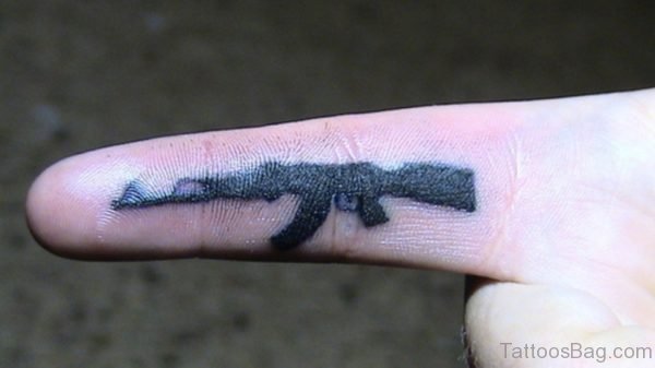 Black Gun Tattoo On Finger