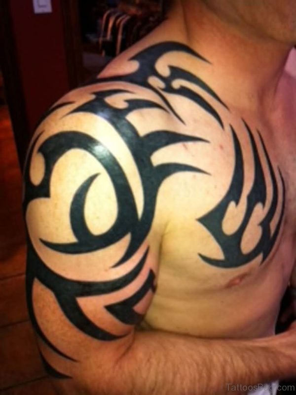 Black Ink Tribal Tattoos On Chest And Shoulder