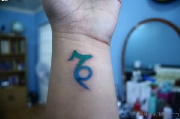 Blue And Green Capricorn Tattoo On Wrist