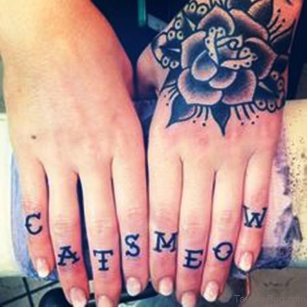 Cats Lettering Tattoo On Finger