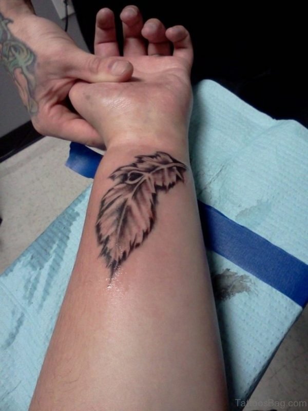 Classy Peacock Feather Wrist Tattoo