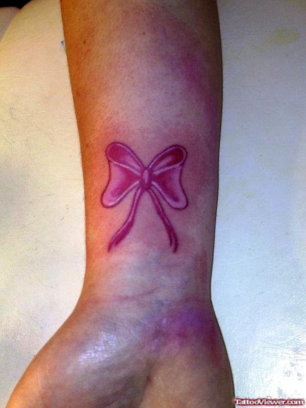 Dark Pink Bow Tattoo On Wrist