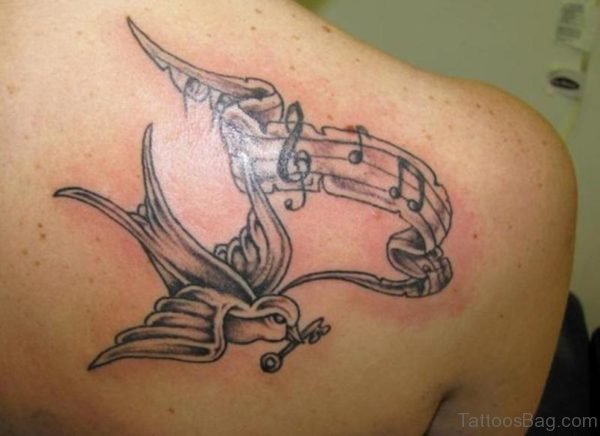 Grey Ink Bird And Music Tattoo