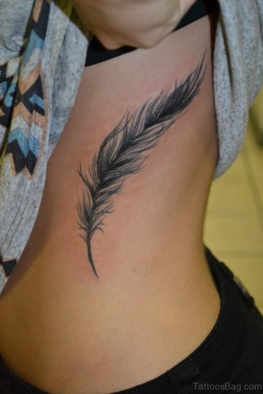 Grey Ink Feather Tattoo On Girl Rib Cage