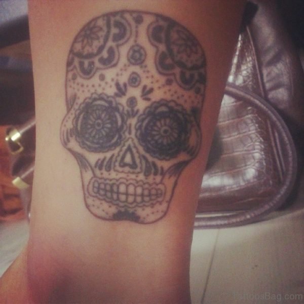 Grey Ink Suagr Skull Tattoo On Ankle
