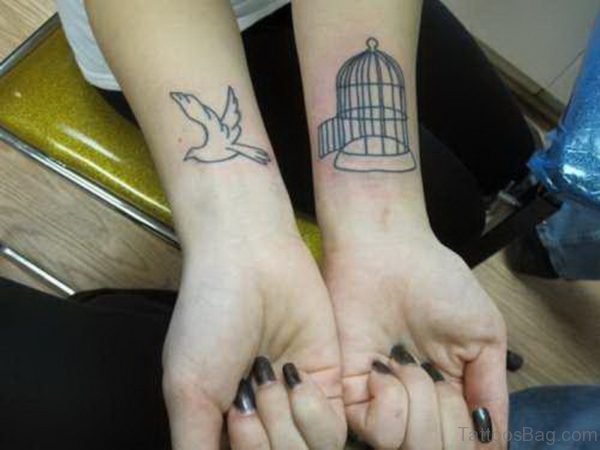 Large Bird And Cage Wrist Tattoo