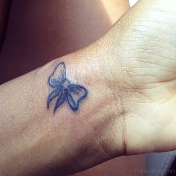 Little Blue Bow Tattoo On Wrist