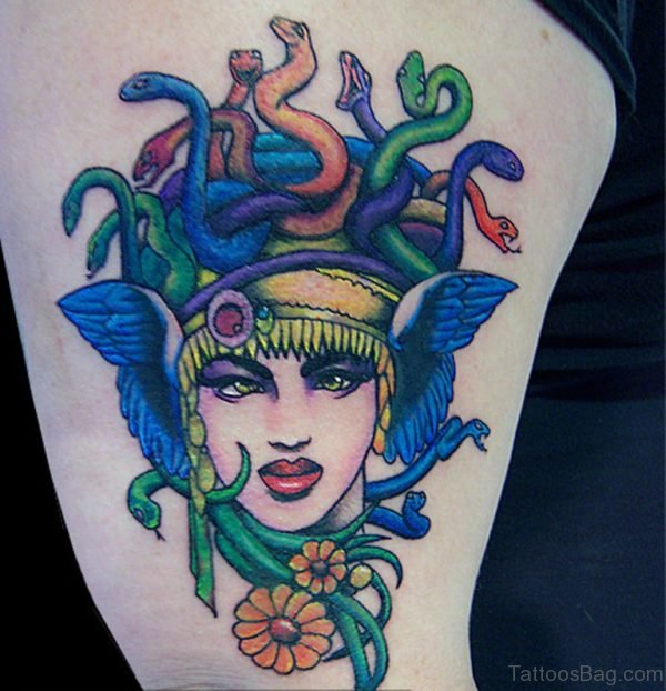 Medusa Tattoo With Flowers On Thigh