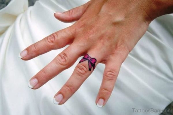 Pink Bow Tattoo On Ring Finger