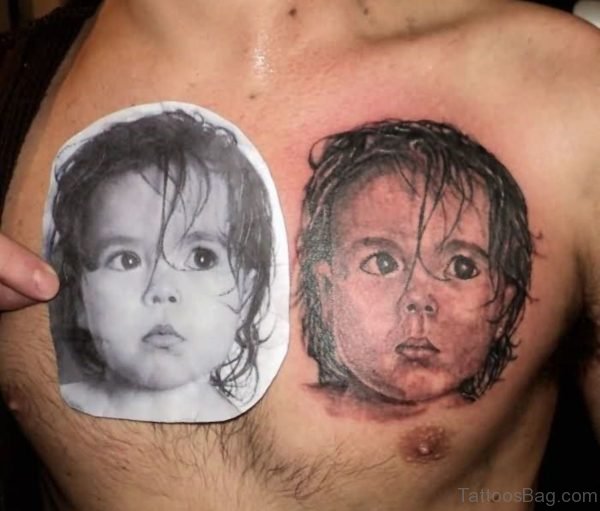 Realistic Baby Face Portrait Tattoo On Man Chest