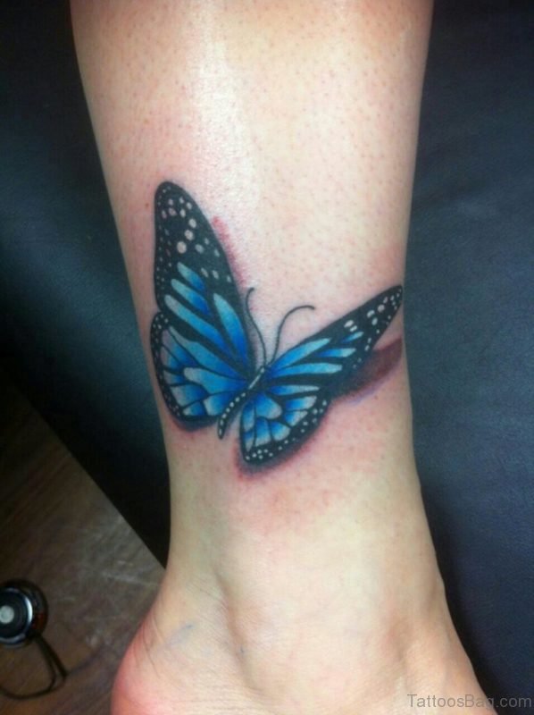 Realistic Black And Blue Butterfly Tattoo On Ankle