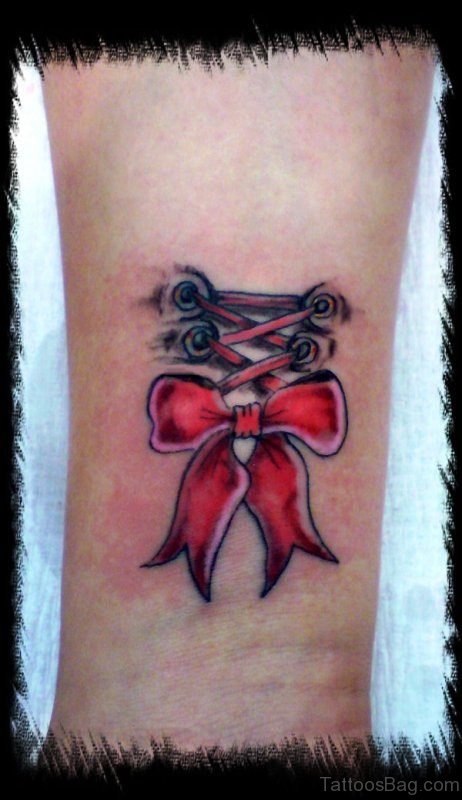 Red Ribbon Bow Tattoo On Wrist