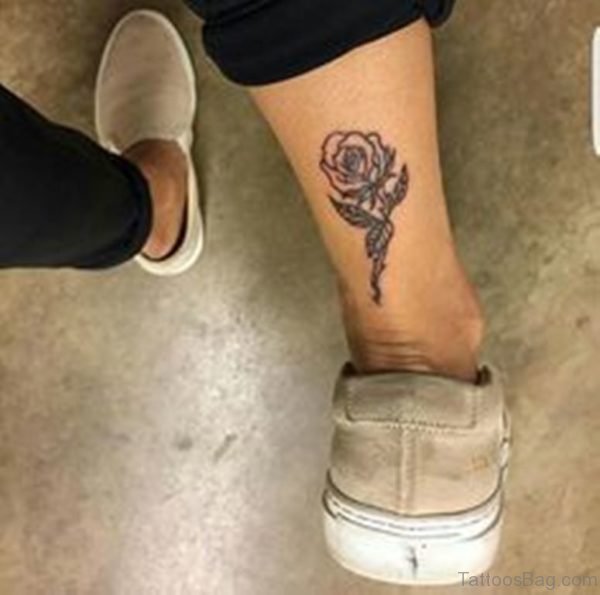 Rose tattoo on back lower leg.