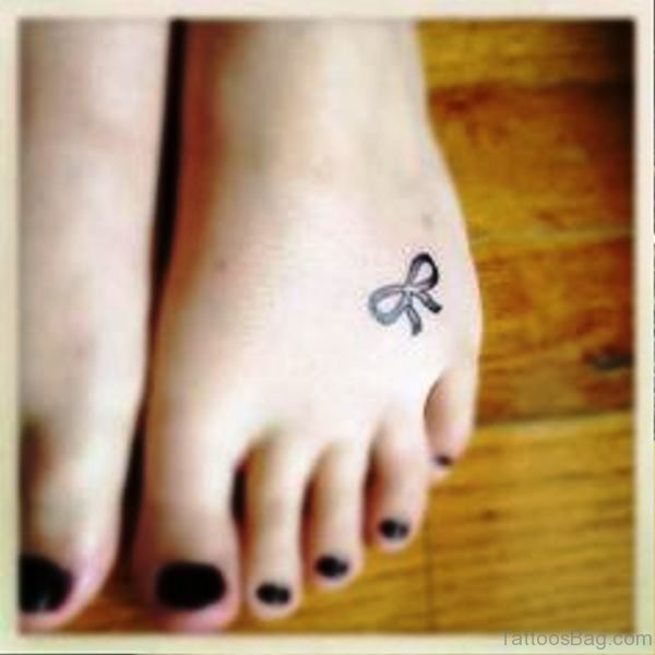 Small Black Bow Tattoo On Foot