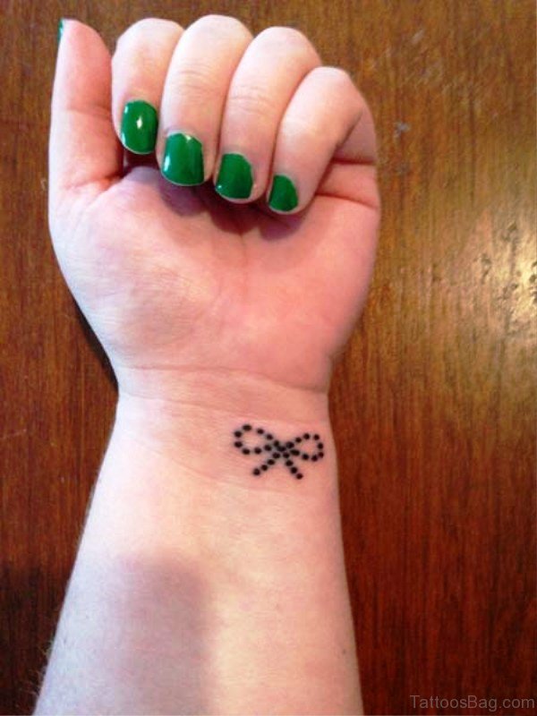 Small Dotted Bow Tattoo On Wrist