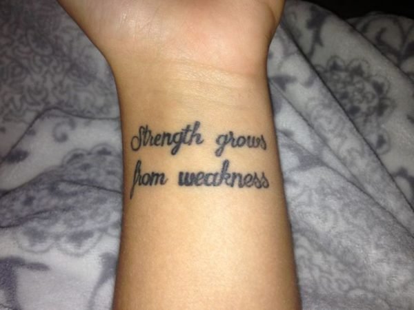 Strength Grows Quote Tattoo On Wrist
