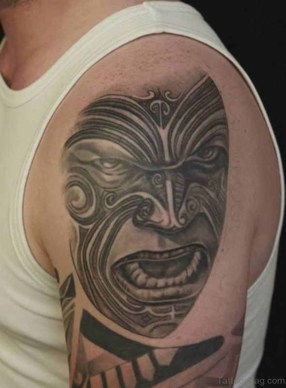 Tribal Black And Grey Mask Tattoo On Shoulder 