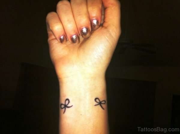Two Black Bows Tattoo On Wrist