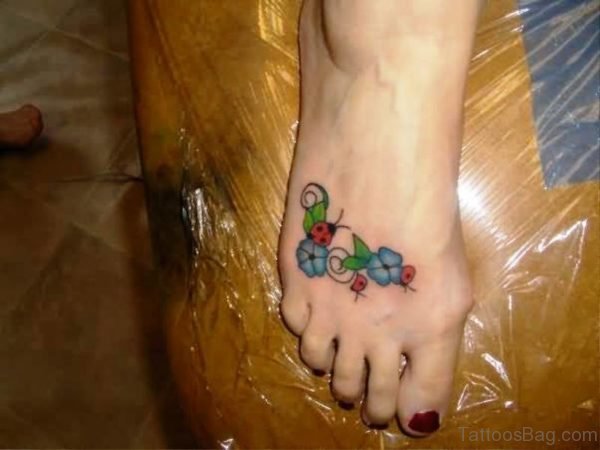 Unique Ladybug Tattoo On Flowers 