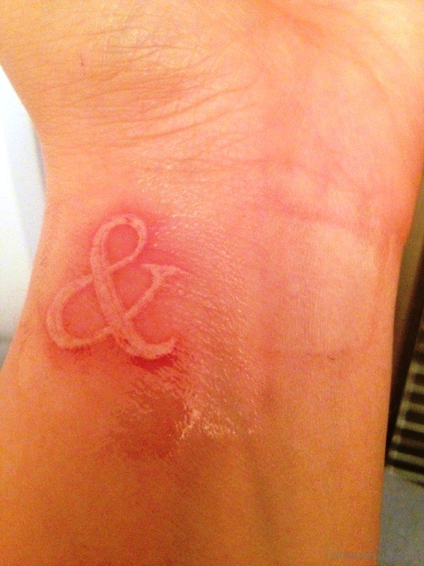 White Ampersand Tattoo On Wrist 