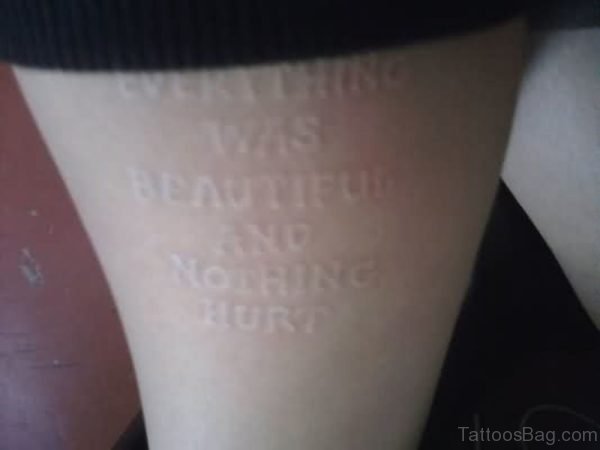 White Ink Wording Tattoo On Thigh