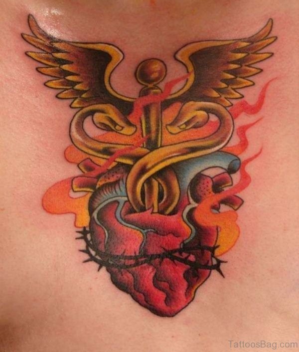 Winged Cross And Human Heart Tattoo