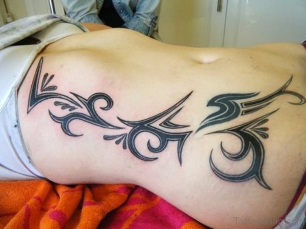 Wonderful Tribal Tattoo On Rib Side For Girls