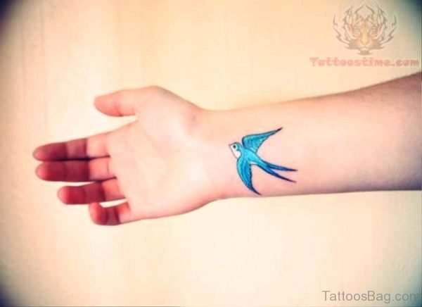Adorable Blue Bird Tattoo On Wrist