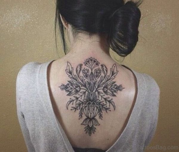 Black Ink Floral Tattoo On Girl Upper Back