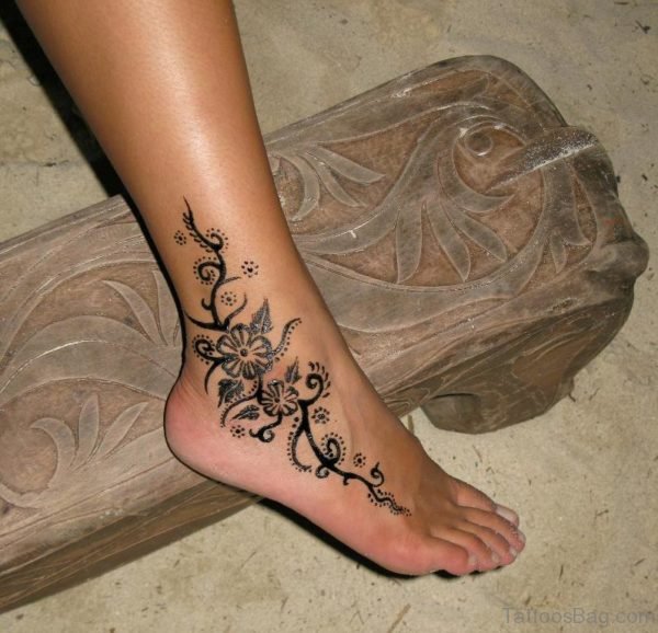 Black Ink Flower Tattoo On Ankle