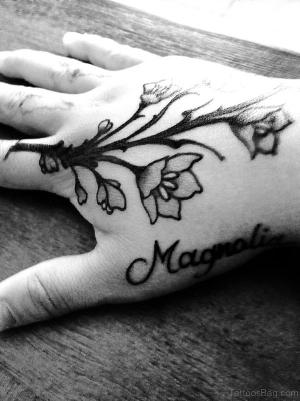 Black Magnolia Tattoo On Hand 