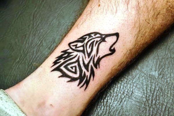Black Tribal Alpha Wolf Tattoo On Arm Image
