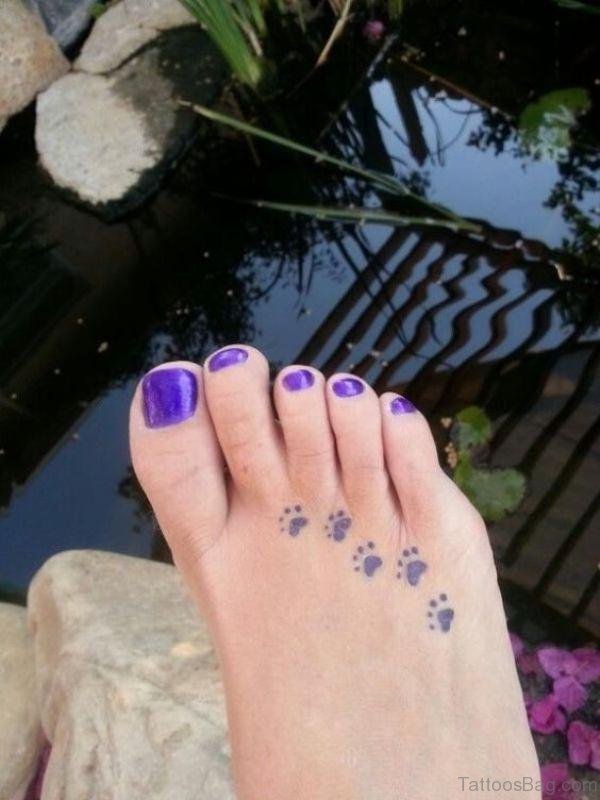 Blue Ink Paw Tattoo On Foot