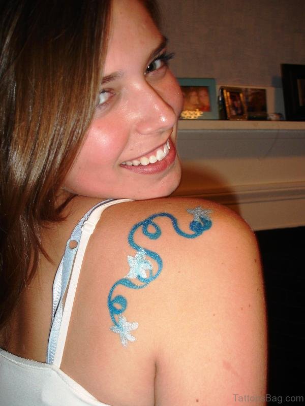 Blue Inked Tattoo On Back Shoulder