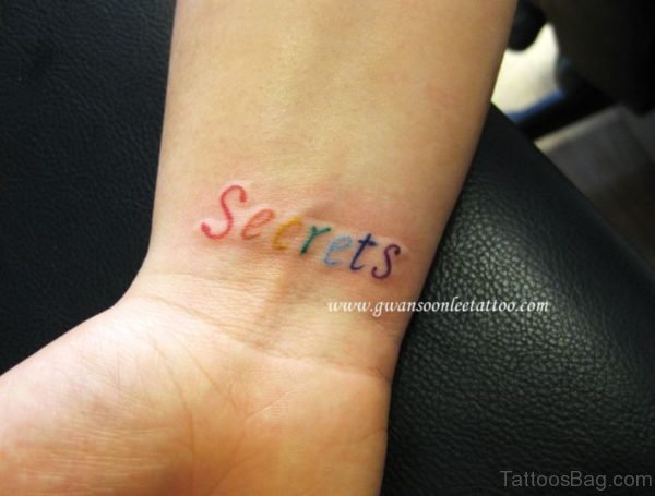 Colored Word Tattoo On Wrist 