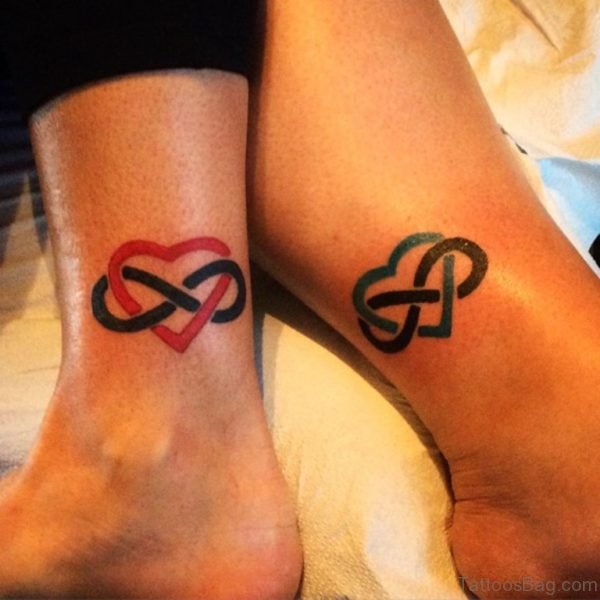Colorful Heart Black Ink Infinity Tattoo Design On Girl Ankle