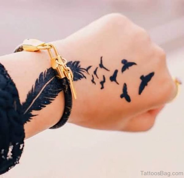 Flying Birds And Nice Feather Tattoo On Hand