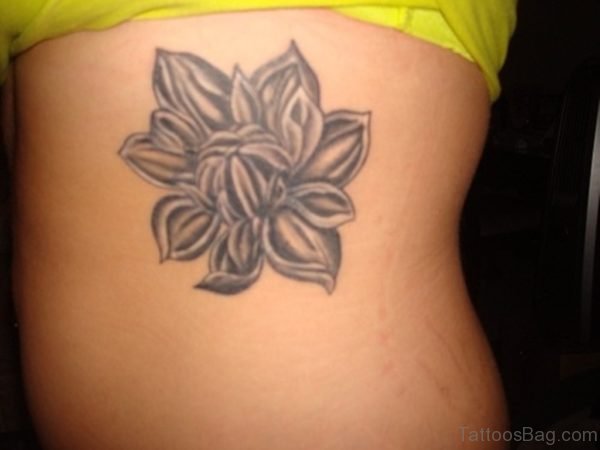 Grey Magnolia Flower Tattoo On Rib 